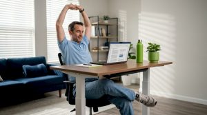 Man stretching during home office work routine