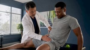 Physical therapist assessing patient hip pain