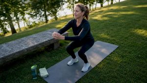Woman doing rehab knee exercise at home gym