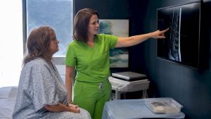 Physician explaining pain procedure to patient