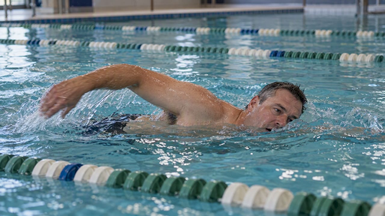 Adult swimming an easy lap in a pool