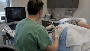 Physician guiding a hip injection with ultrasound