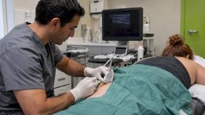 Clinician guiding a hamstring tendon injection with ultrasound